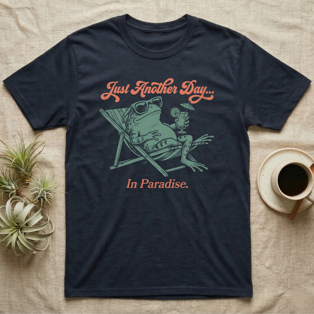 Fire-Bellied Toad Paradise T-Shirt in Navy — Illustrated fire-bellied toad reclining in a beach chair with sunglasses and a cocktail, coral script reading Just Another Day In Paradise.