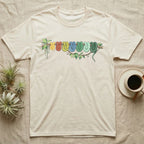 Green Tree Python Canopy Crew T-Shirt in Natural — Watercolor illustration of a green tree python in seven real colour-change stages coiled on a branch, dark grey T-shirt design.
