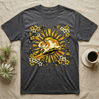 Dark gray t-shirt with a golden hamster and floral sunburst graphic.