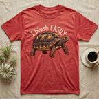Red-Foot Tortoise Blush T-Shirt in Heather Red — Red-footed tortoise with red-orange cheeks and legs walking under the curved words I blush EASILY