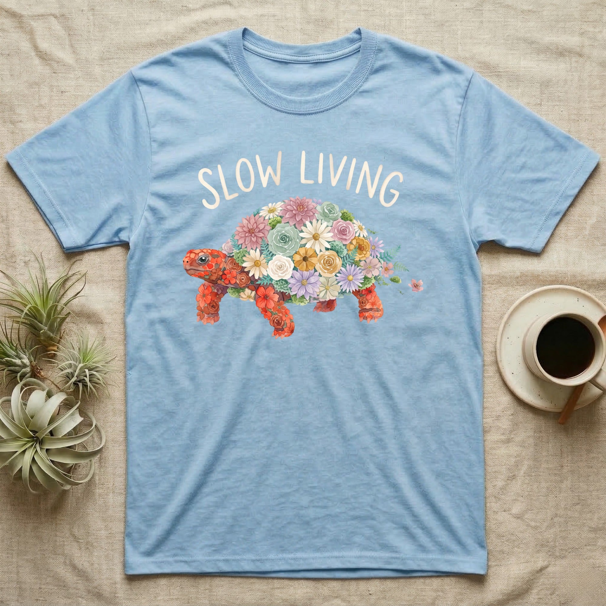Red-Foot Tortoise Slow Living T-Shirt in Light Blue — Flat watercolour mosaic of a red-foot tortoise built entirely from terrarium flowers and ferns.