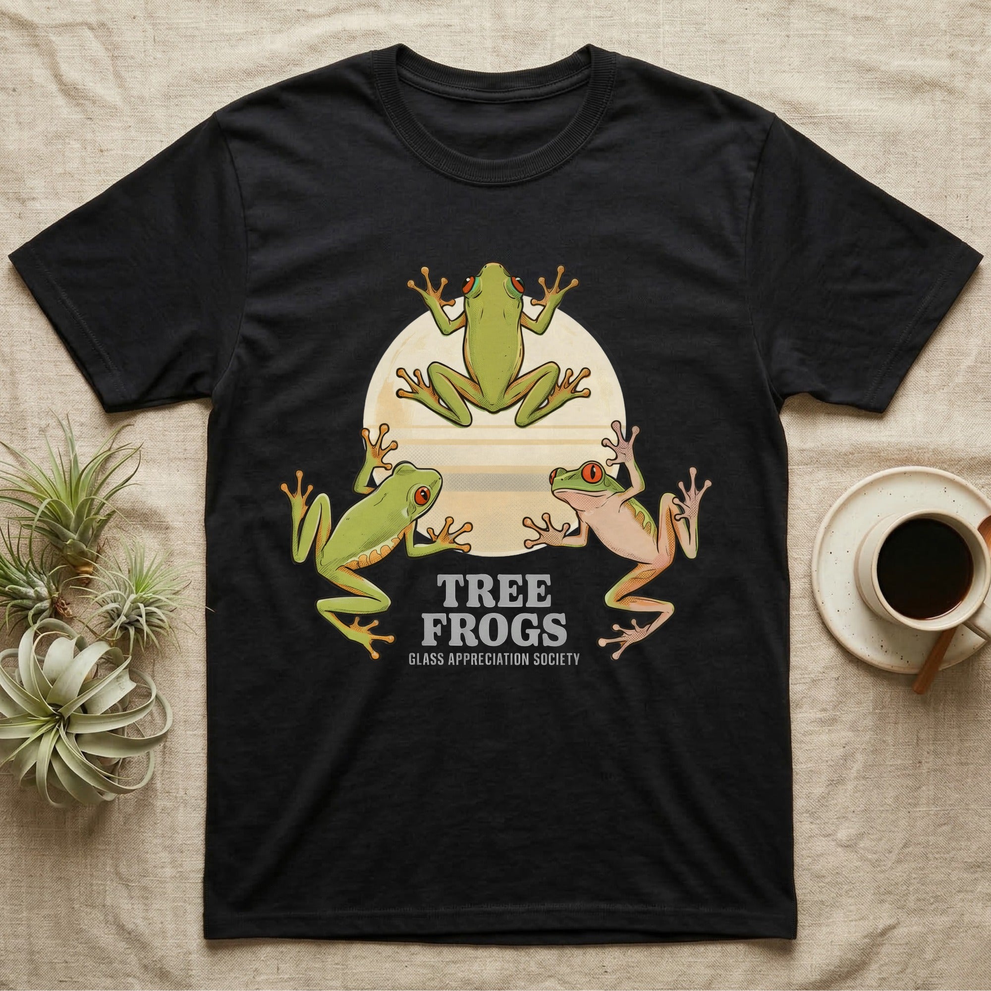 Three Tree Frog Moon T-Shirt in Black — Retro-illustration of three tree frogs in splayed glass-cling poses around a stratified halftone full moon.