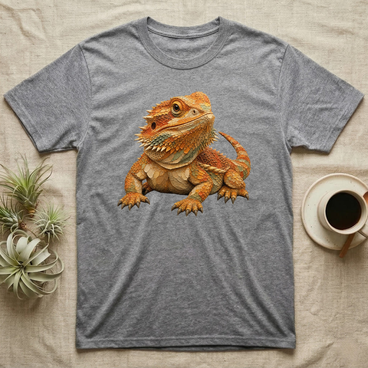 Grey t-shirt with a detailed illustration of an orange bearded dragon.