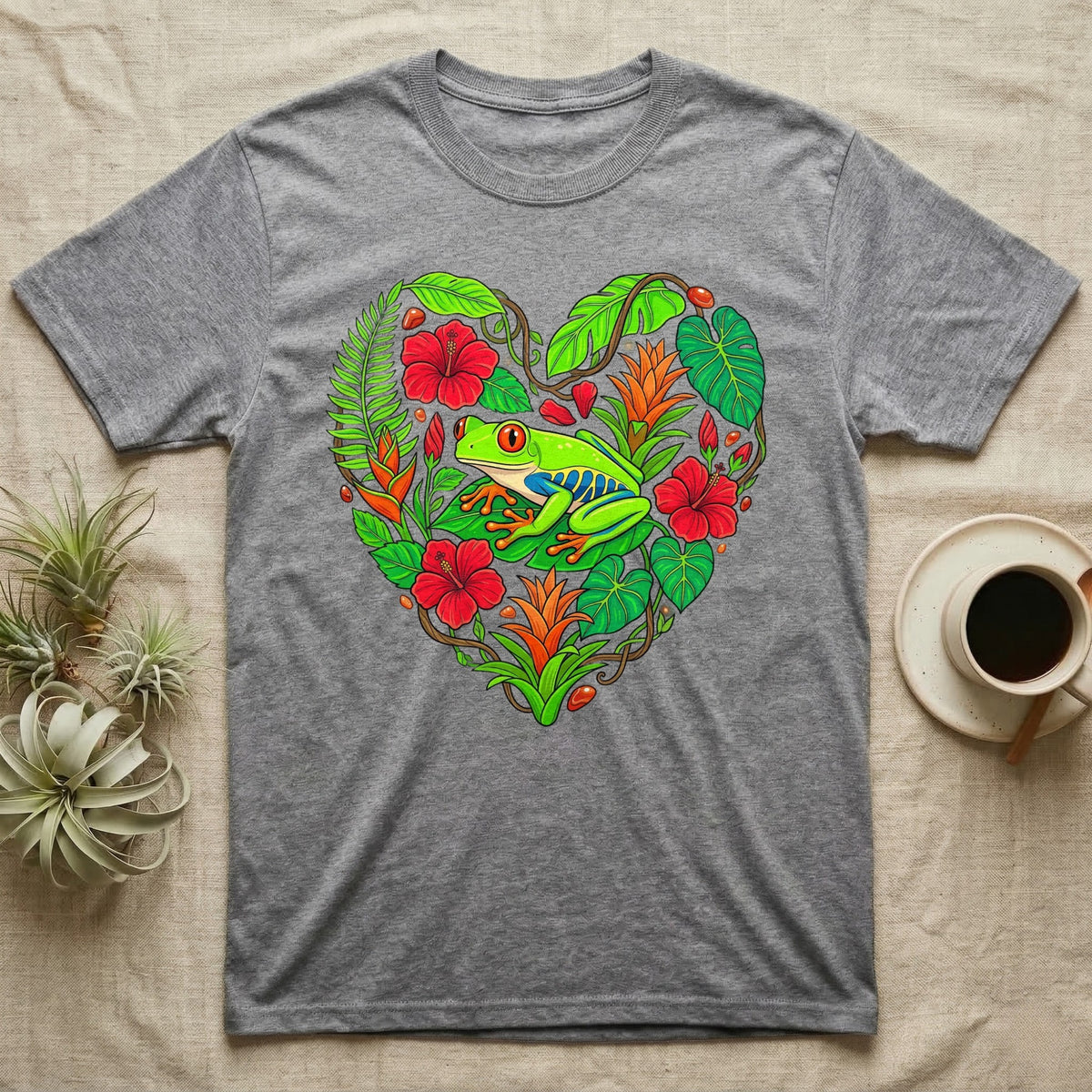 Gray t-shirt featuring a heart-shaped design of tropical leaves, flowers, and a frog.