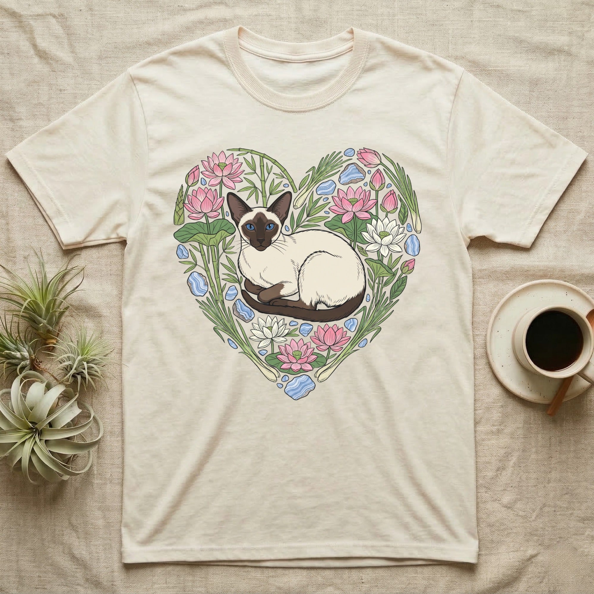 Cream t-shirt with Siamese cat and floral heart graphic.