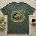 Russian Tortoise Spring T-Shirt in Military Green — Botanical illustration of a Russian tortoise stepping into spring grass framed by daffodils and early shoots.