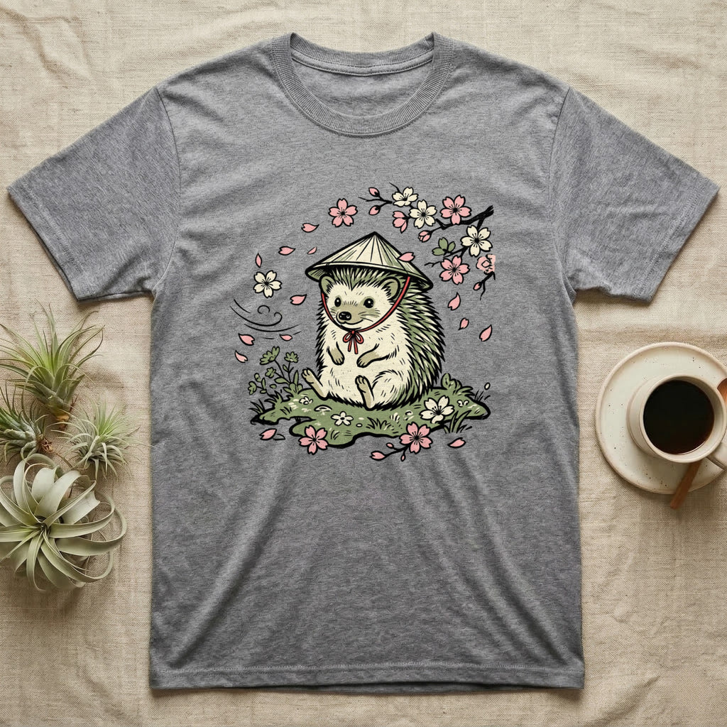 Grey t-shirt with a cartoon hedgehog wearing a conical hat and surrounded by cherry blossoms.