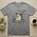 Grey t-shirt with a cartoon hedgehog wearing a conical hat and surrounded by cherry blossoms.