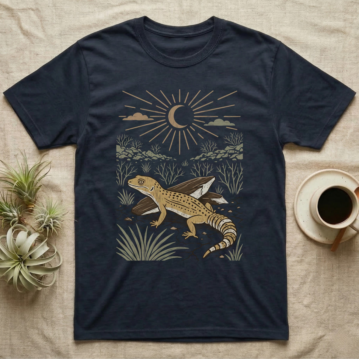 Leopard Gecko Home Range T-Shirt in Navy — Woodcut-style illustration of a leopard gecko standing on cracked earth beside flat stones with thorn scrub behind, no on-shirt text.