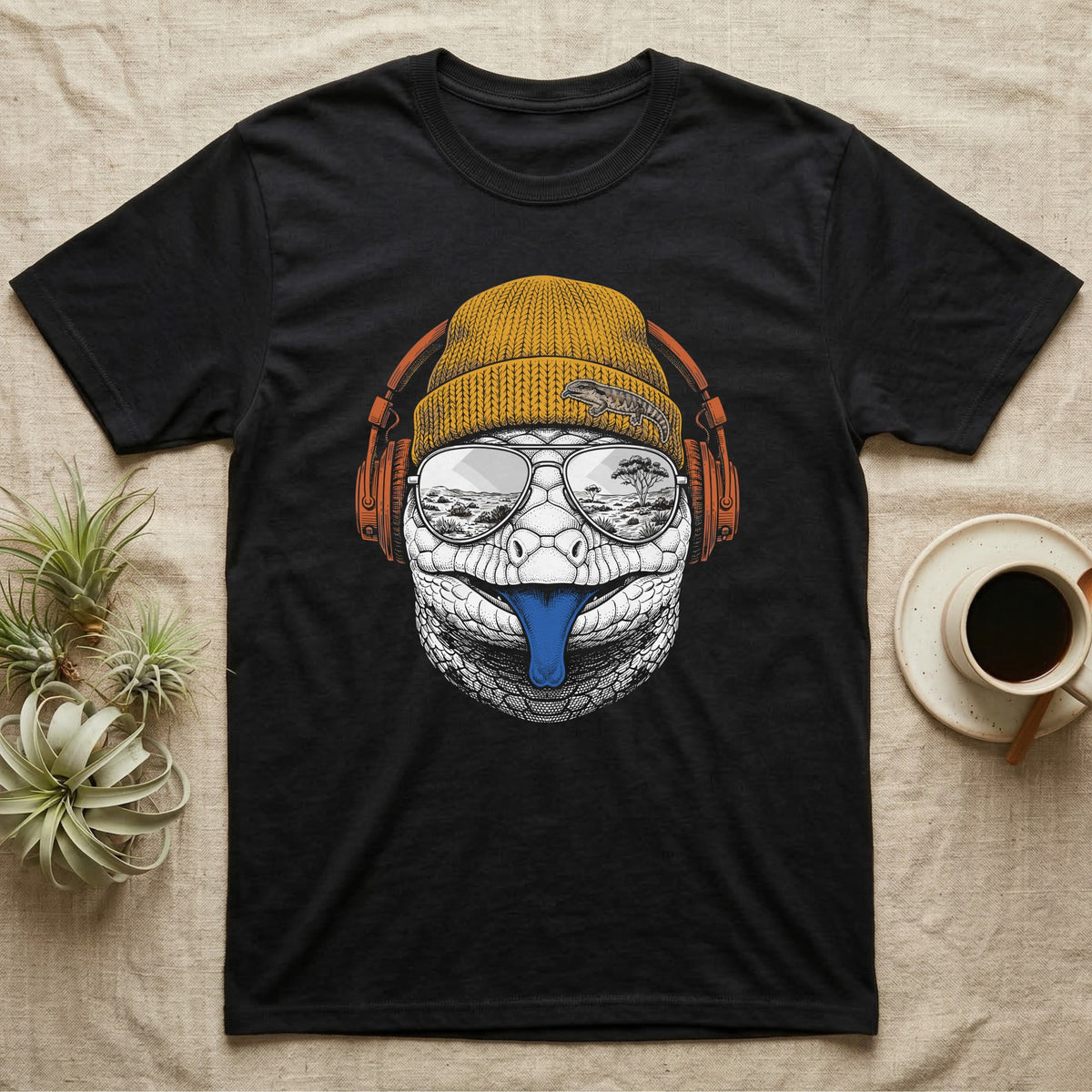 Blue-Tongued Skink Headphones T-Shirt in Black — Engraved blue-tongued skink with cobalt tongue out, wearing a beanie and headphones, aviators reflecting the outback.