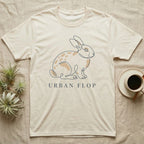 Cream t-shirt with minimalist rabbit line art and "URBAN FLOP" text.