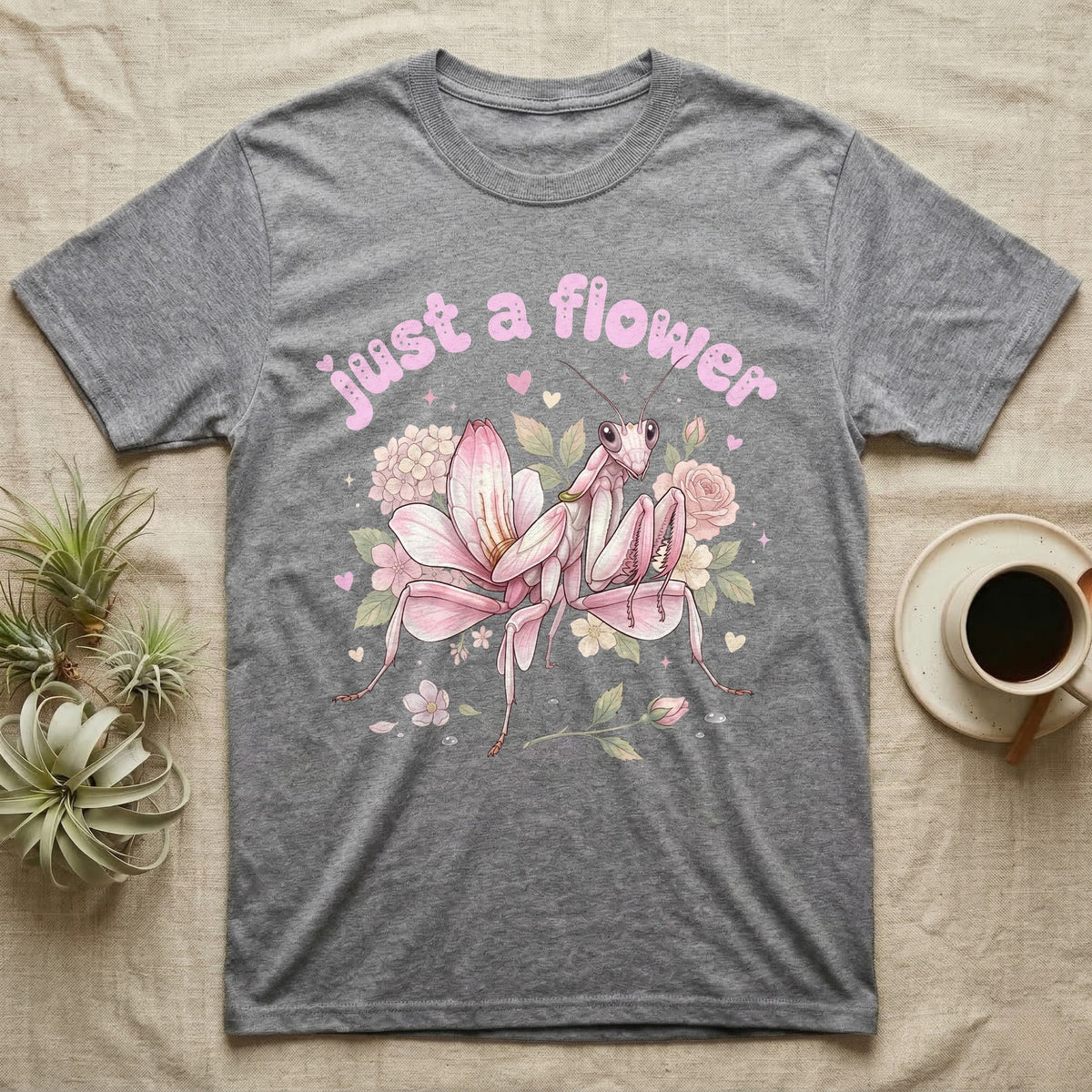 Orchid Mantis Softie T-Shirt in Sport Grey — Pink orchid mantis mimicking a flower under pastel bubble text "just a flower" with tiny hearts.