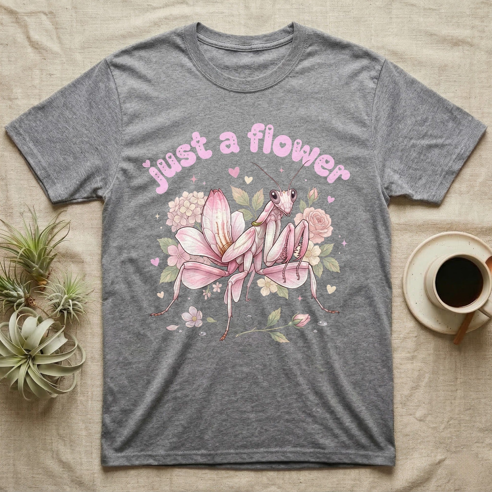 Orchid Mantis Softie T-Shirt in Sport Grey — Pink orchid mantis mimicking a flower under pastel bubble text "just a flower" with tiny hearts.