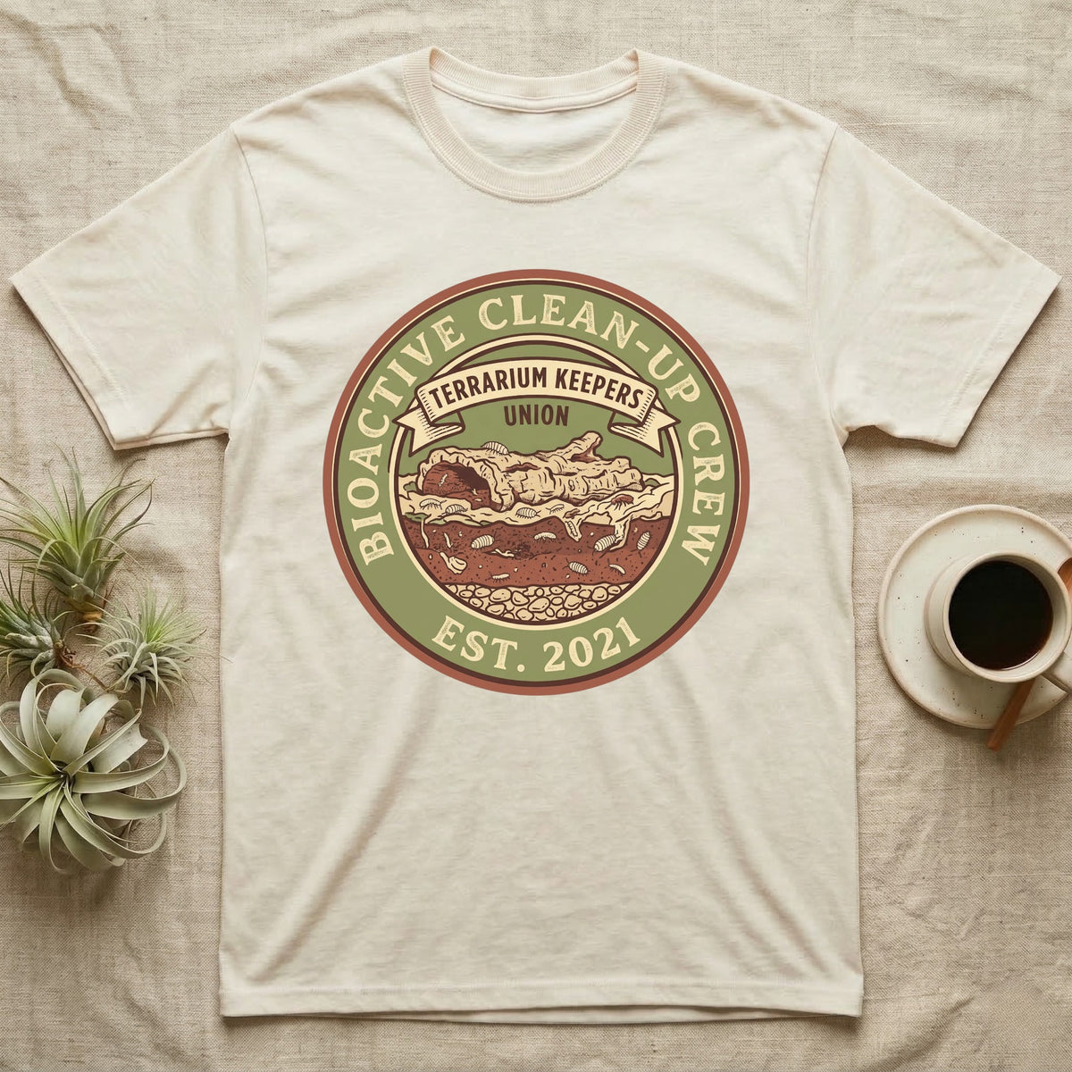 Isopod Terrarium Keepers Union T-Shirt in Natural — Vintage union badge showing a cross-sectioned bioactive vivarium worked by isopods and springtails.