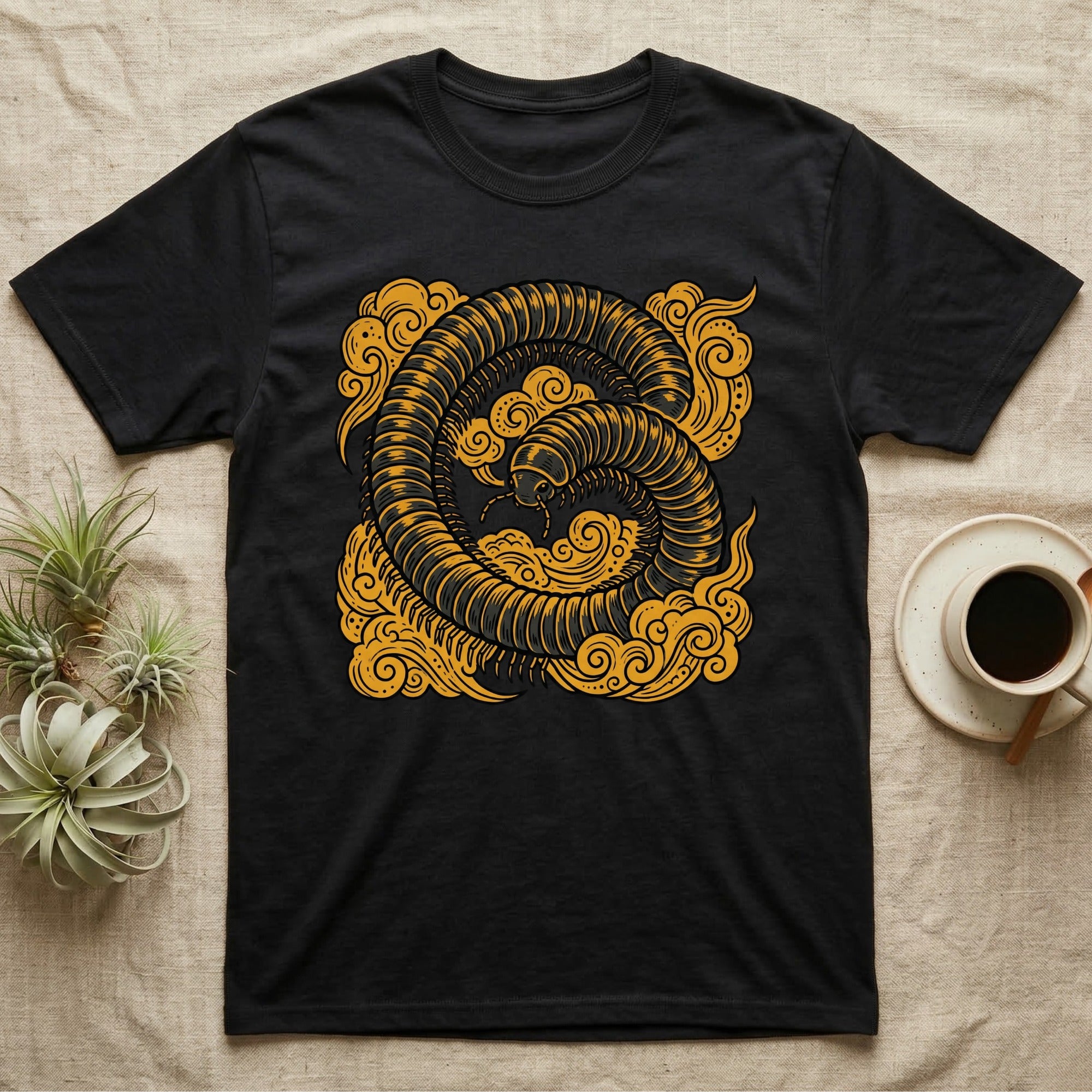 Black t-shirt with golden millipede and cloud design.