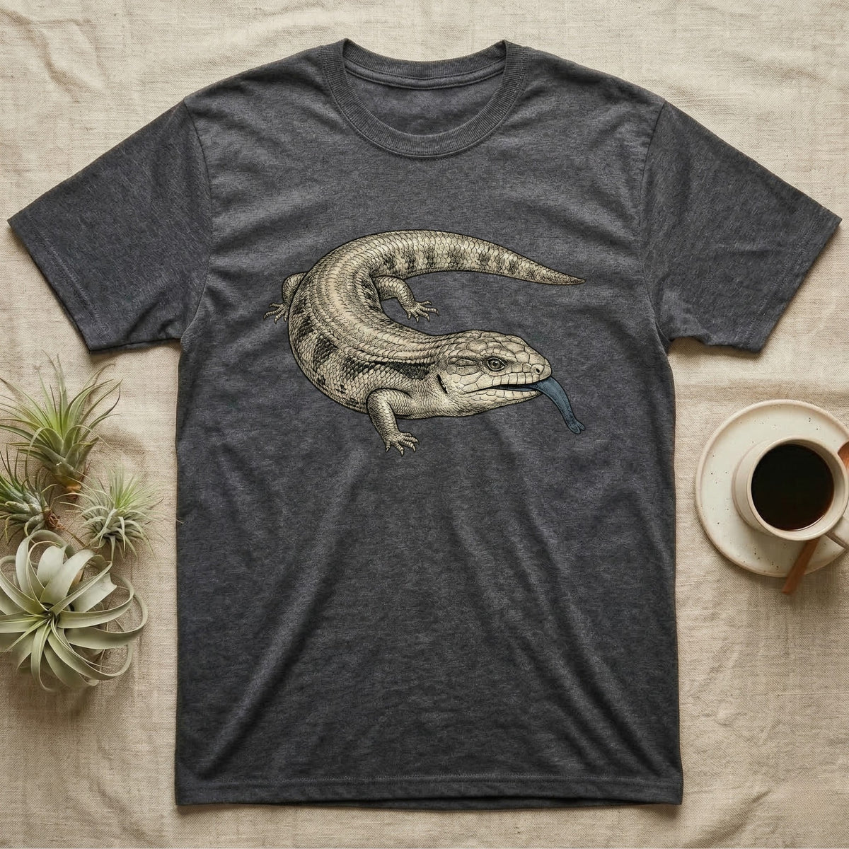 Dark grey t-shirt with a blue-tongued skink graphic on the chest.