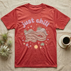 Rosy Boa Softie T-Shirt in Heather Red — Relaxed coiled rosy boa with sleepy eyes under pastel bubble text "just chill" with tiny hearts.