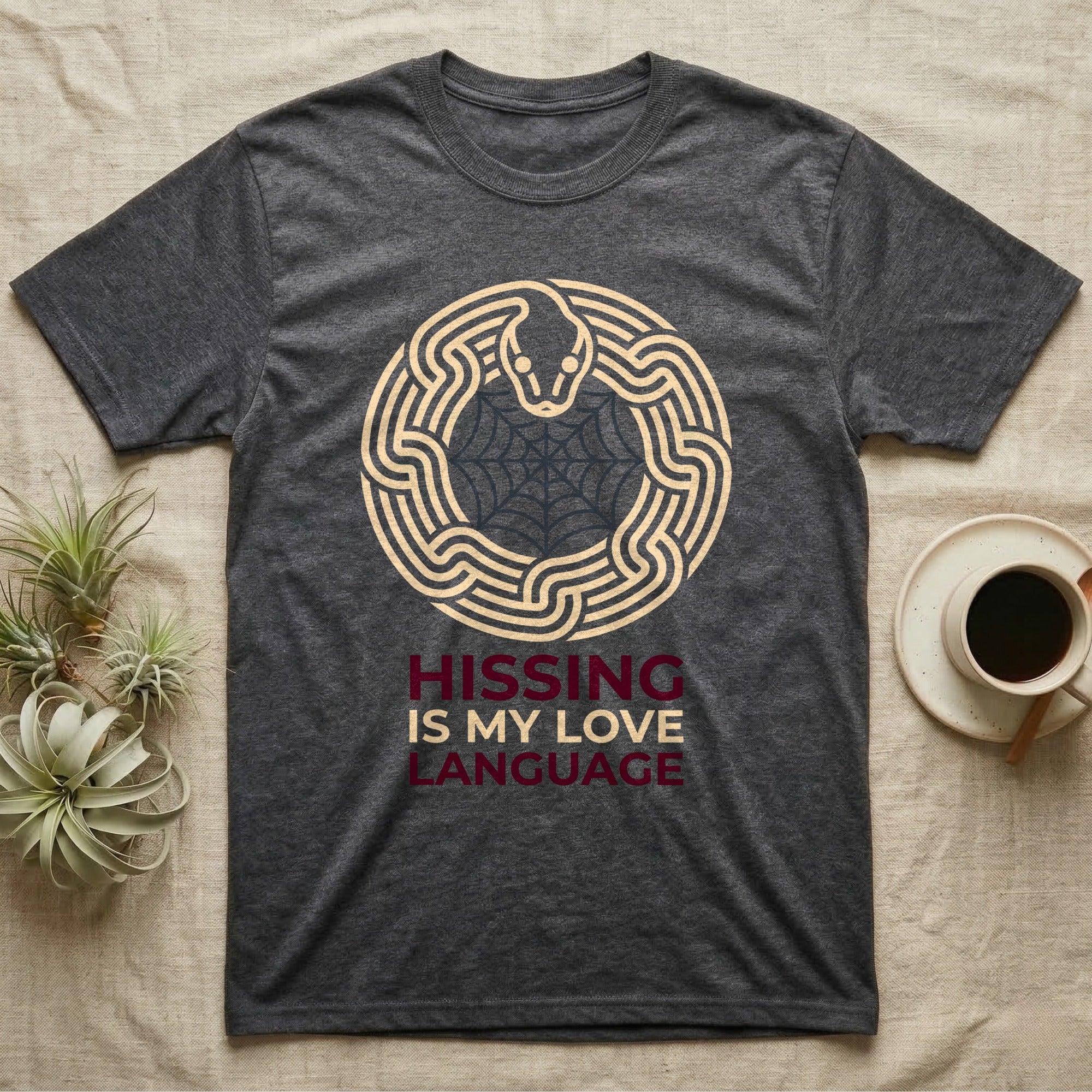 Ball Python Hissing Spiderweb T-Shirt in Dark Heather — Minimal continuous-line ball python coiled around a faint spiderweb, "Hissing Is My Love Language."