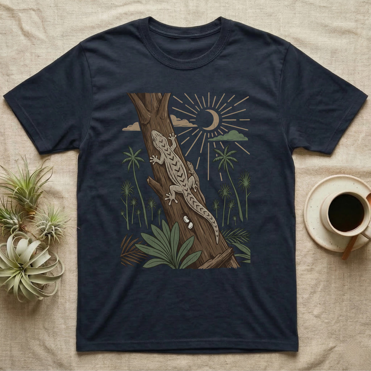 Mourning Gecko Home Range T-Shirt in Navy — Woodcut-style illustration of two mourning geckos on a palm trunk with a pair of eggs in the bark and palms behind, no on-shirt text.
