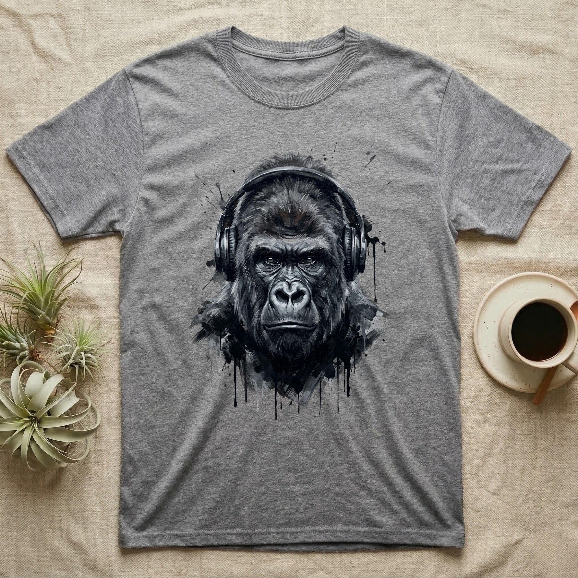 Grey t-shirt with black and white illustration of a gorilla wearing headphones.