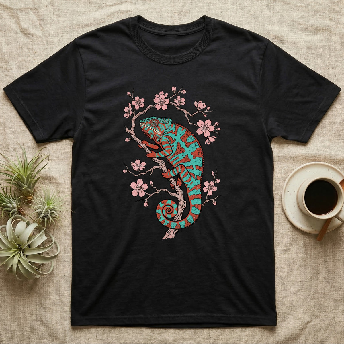 Black t-shirt with teal and coral chameleon on cherry blossom branch.