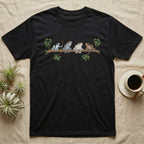 Amazon Milk Frog Branch T-Shirt in Black — Four banded Amazon milk frogs perched along one slender branch, drawn in loose ink line and soft watercolour wash.