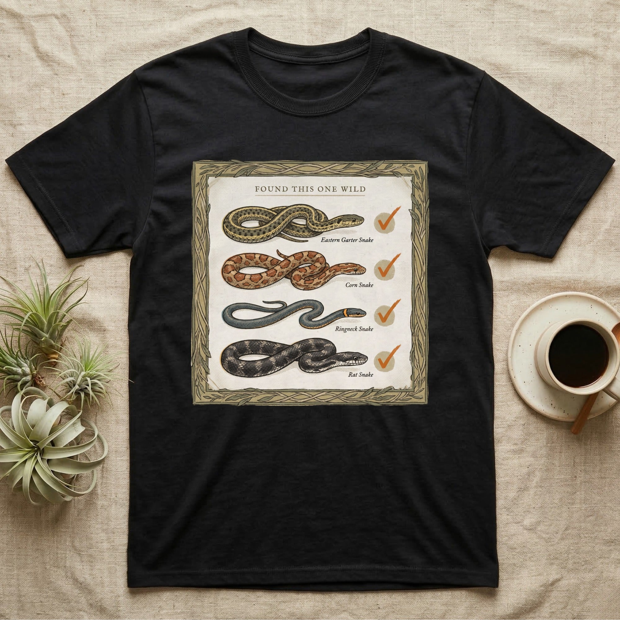 Native Snake Life List T-Shirt in Black — Vintage field-guide life list of native snakes drawn as small specimens with tally checkmarks beside each.
