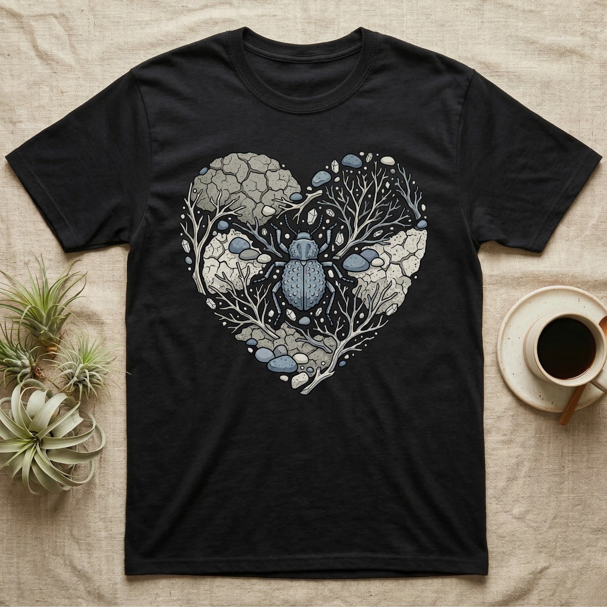 Black t-shirt featuring a heart-shaped design with a beetle and organic, rocky elements.