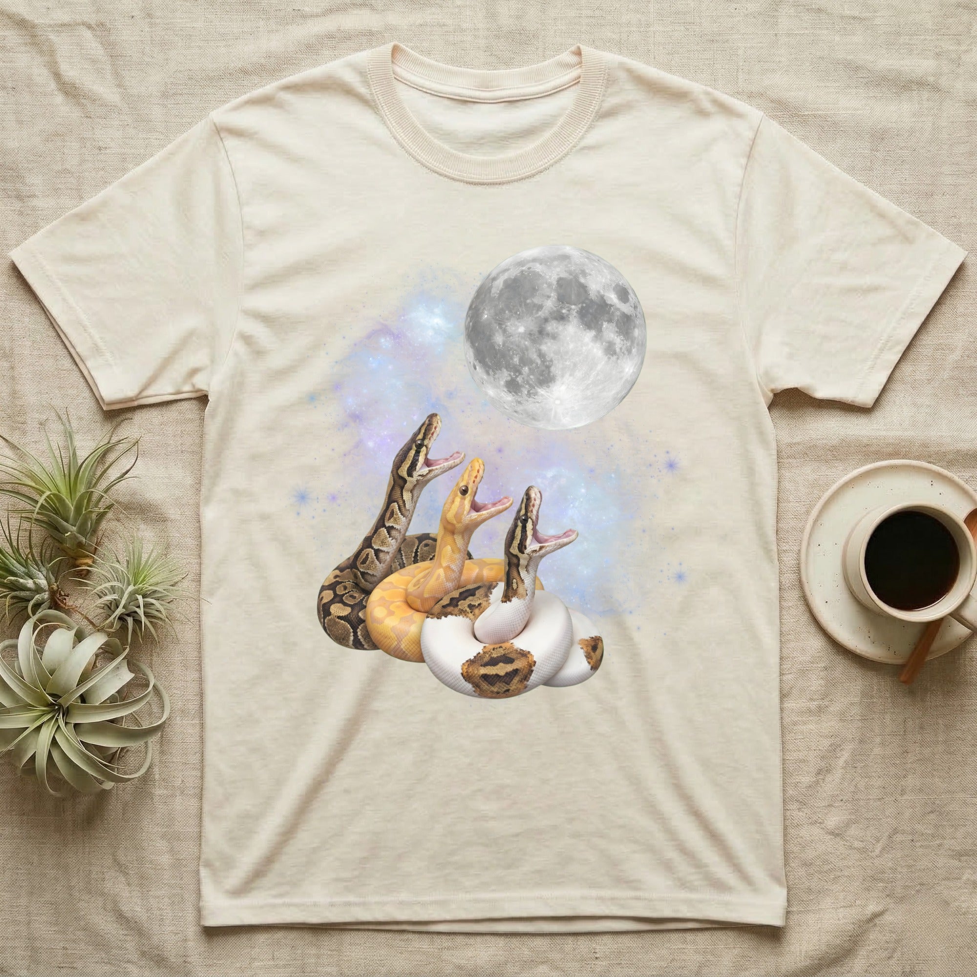 Ball Python Moon Howl T-Shirt in Natural — Three Ball Python colour morphs howling at a full moon over a nebula on a dark grey t-shirt.