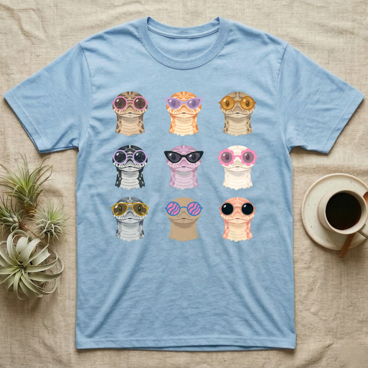 Hognose Morphs Sunglasses T-Shirt in Light Blue — Gouache grid of nine western hognose snake morphs as frontal busts, each wearing different sunglasses