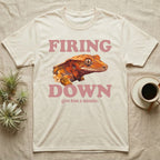 Crested Gecko Firing Down T-Shirt in Natural — Engraved crested gecko in navy ink between the rose words Firing and Down, with give him a minute above.