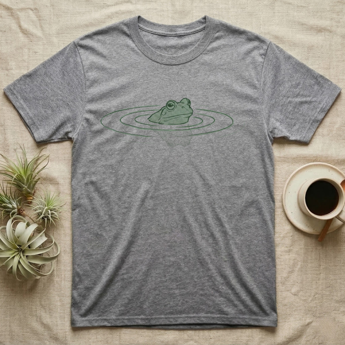 Minimal Swimming Frog T-Shirt in Sport Grey — Minimal single-line illustration of a frog at the waterline with concentric ripple rings and vast negative space.