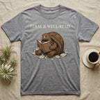 Red-Foot Tortoise Reading T-Shirt in Sport Grey — Pen-and-ink red-foot tortoise seated reading a book in tiny glasses with cross-hatch shading and cream ink