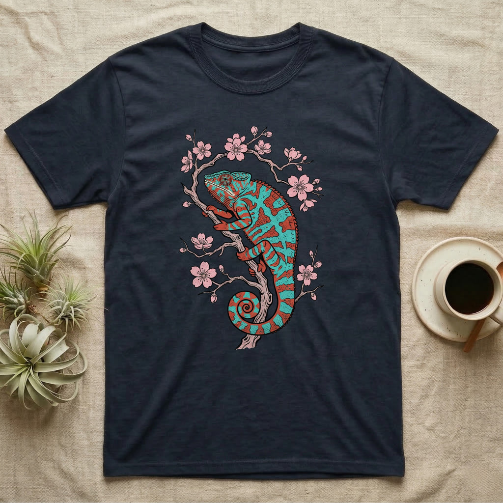Dark t-shirt with a teal and pink chameleon on a blooming branch.