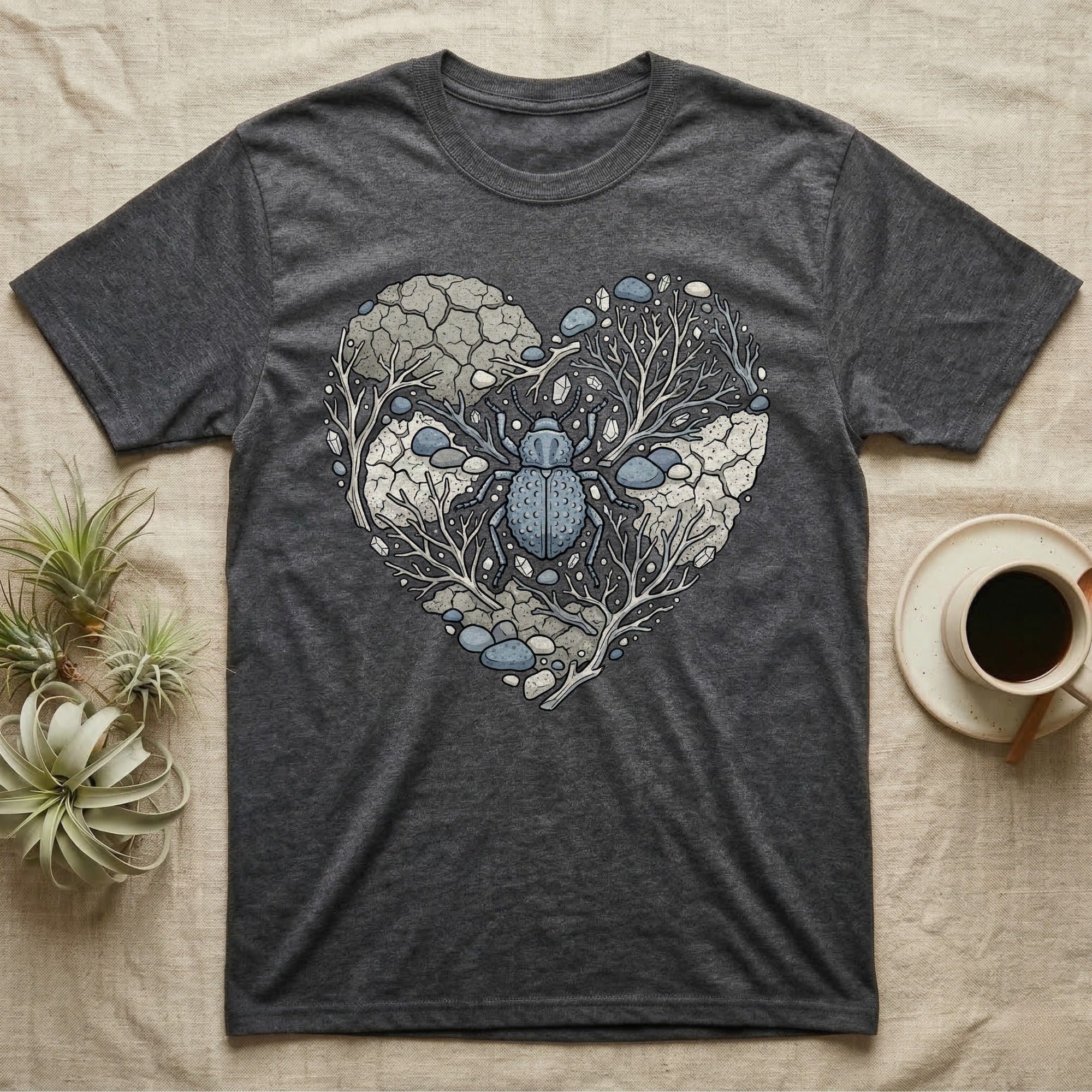 Dark grey t-shirt with heart-shaped graphic of a beetle among rocks and branches.