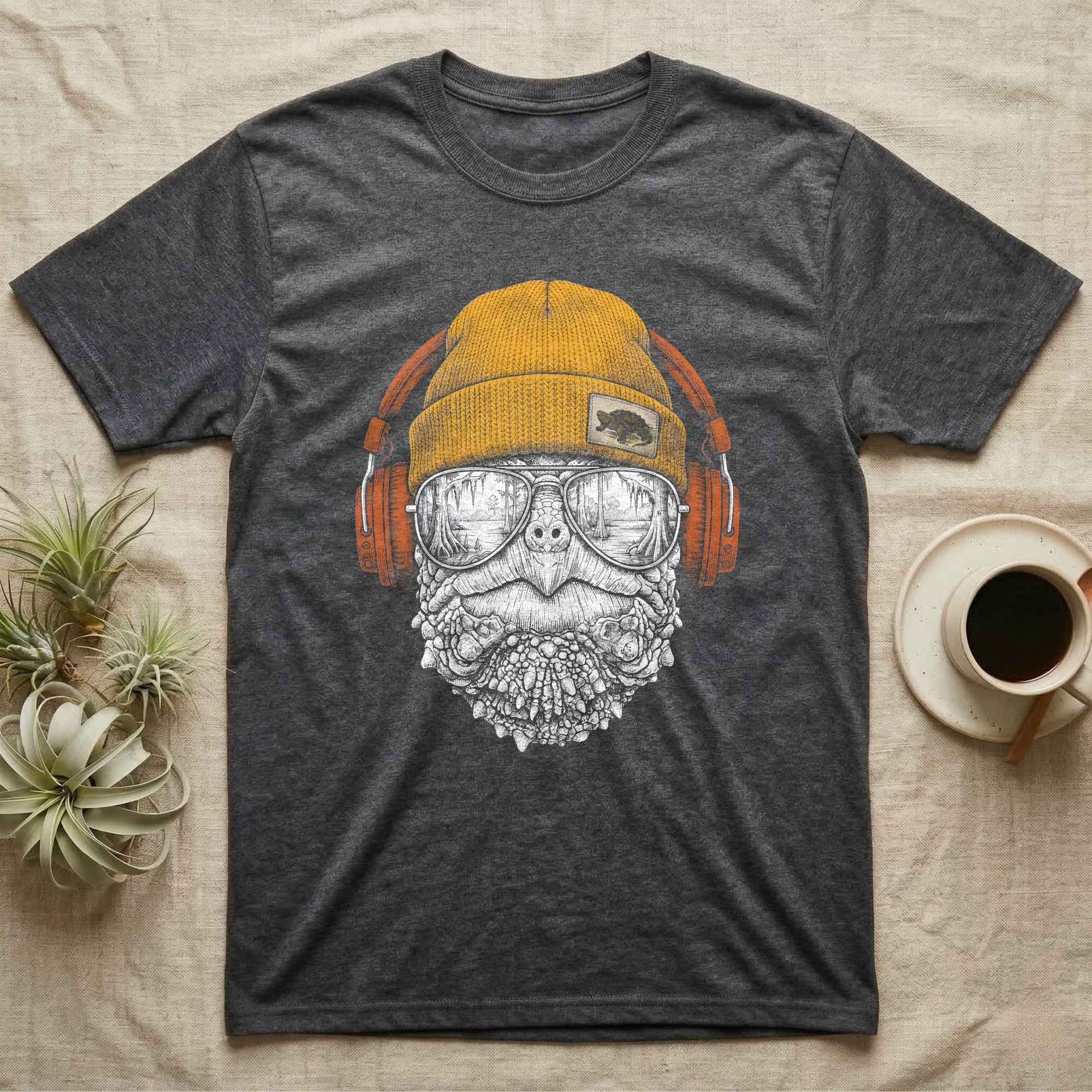 Snapping Turtle Headphones T-Shirt in Dark Heather — Engraved alligator snapping turtle with spiked skin and hooked beak, in a beanie and headphones, swamp reflection.
