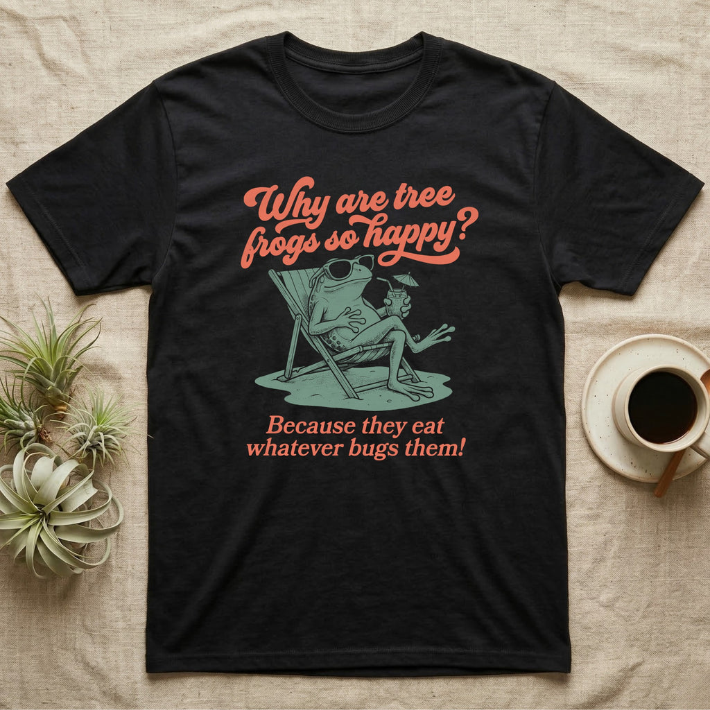 Green Tree Frog Sun Chair T-Shirt in Black — Illustrated green tree frog reclining on a beach chair with sunglasses and a cocktail, coral script asking why tree frogs are so happy because they eat whatever bugs them.
