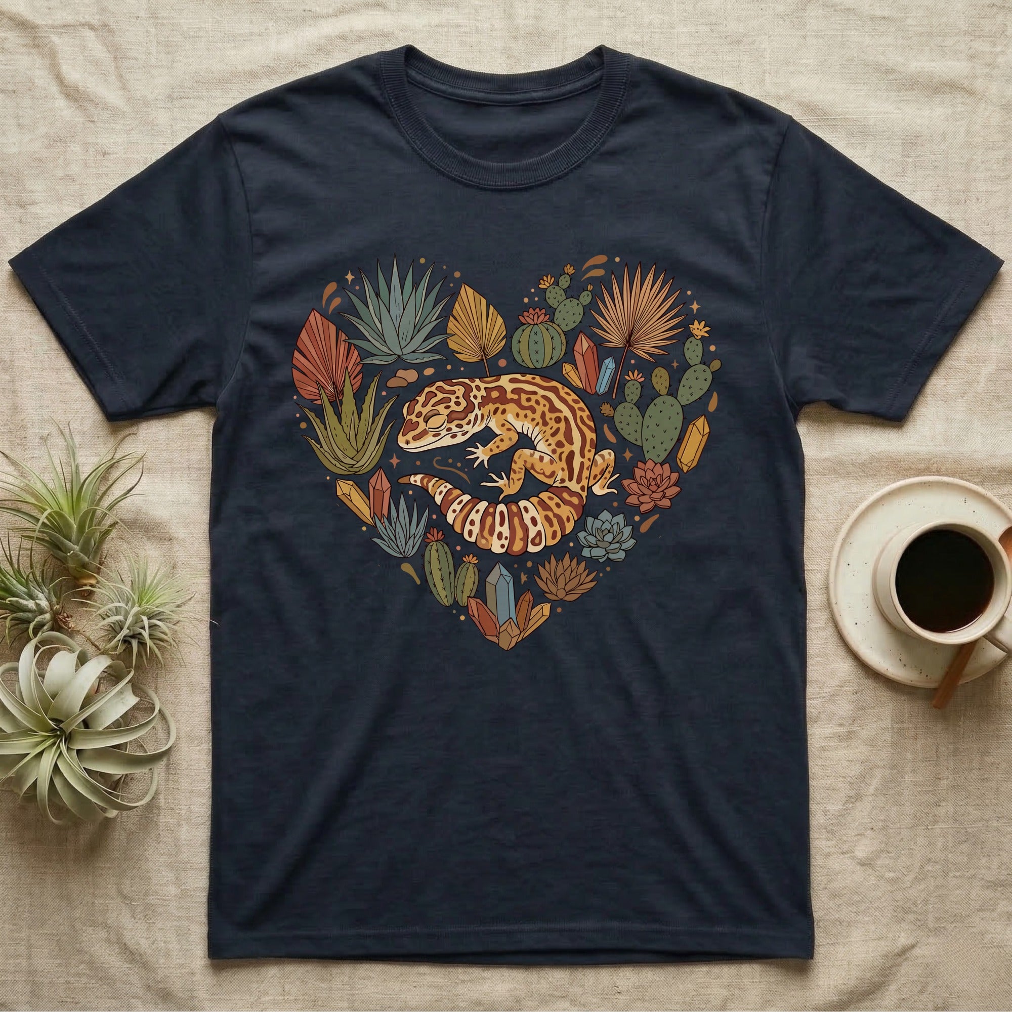 Dark t-shirt with heart-shaped succulent and crystal design featuring a gecko.