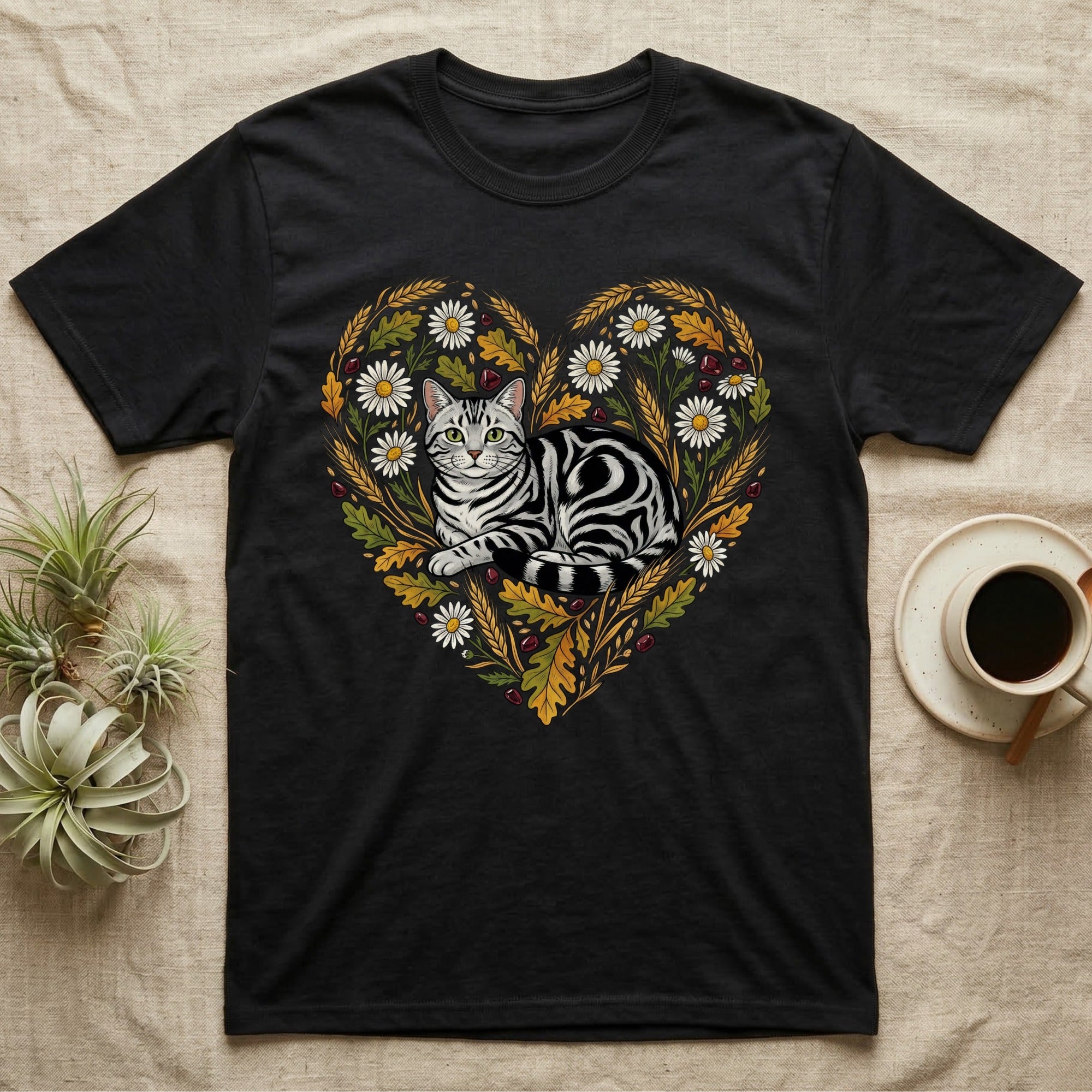 Black t-shirt with a heart-shaped floral design featuring a silver tabby cat.