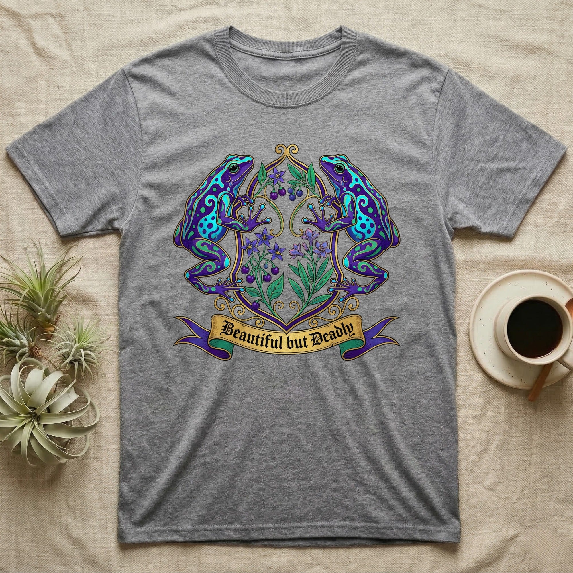Grey t-shirt with a colorful frog and floral crest reading "Beautiful But Deadly".