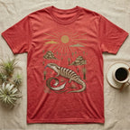 Blue-Tongued Skink Home Range T-Shirt in Heather Red — Woodcut-style illustration of a blue-tongued skink walking across bare soil with its tongue out, shed skin and grass trees behind, no on-shirt text.