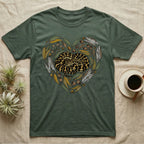 Green t-shirt with heart-shaped graphic of a coiled snake surrounded by eucalyptus leaves and acorns.