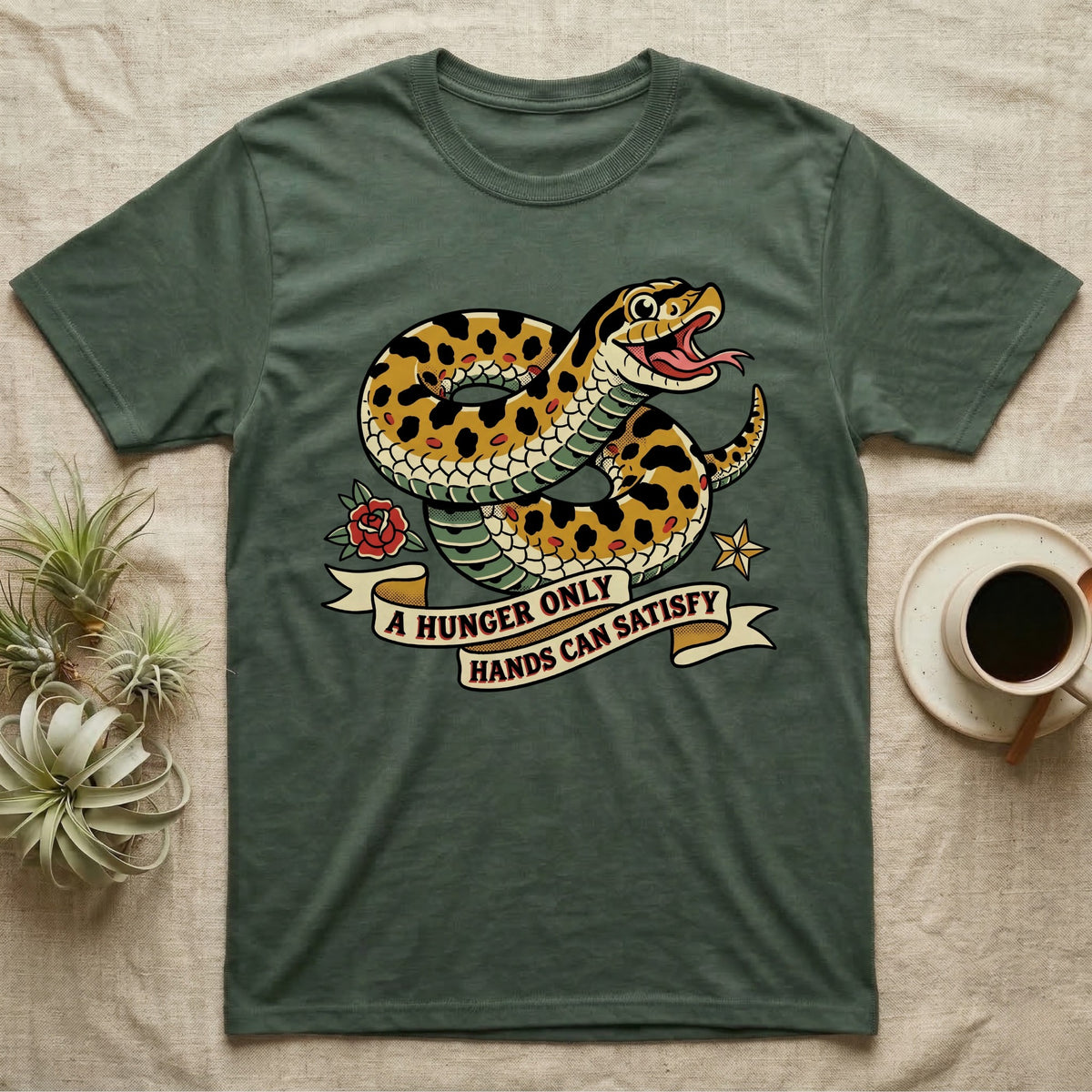 Hognose Hunger Flash T-Shirt in Military Green — American-traditional tattoo-flash illustration of a hognose snake in a heroic coil with a banner reading the feeding-hunger line.