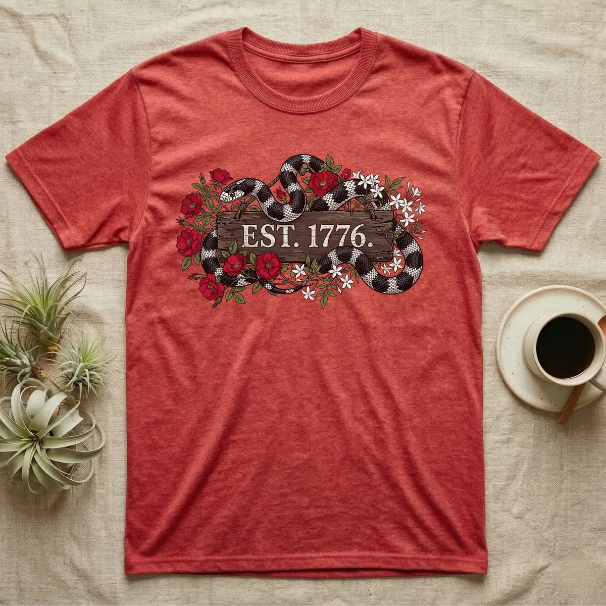 Kingsnake Floral 1776 T-Shirt in Heather Red — Black-and-white California kingsnake woven through roses and jasmine around a wooden sign reading Est. 1776.