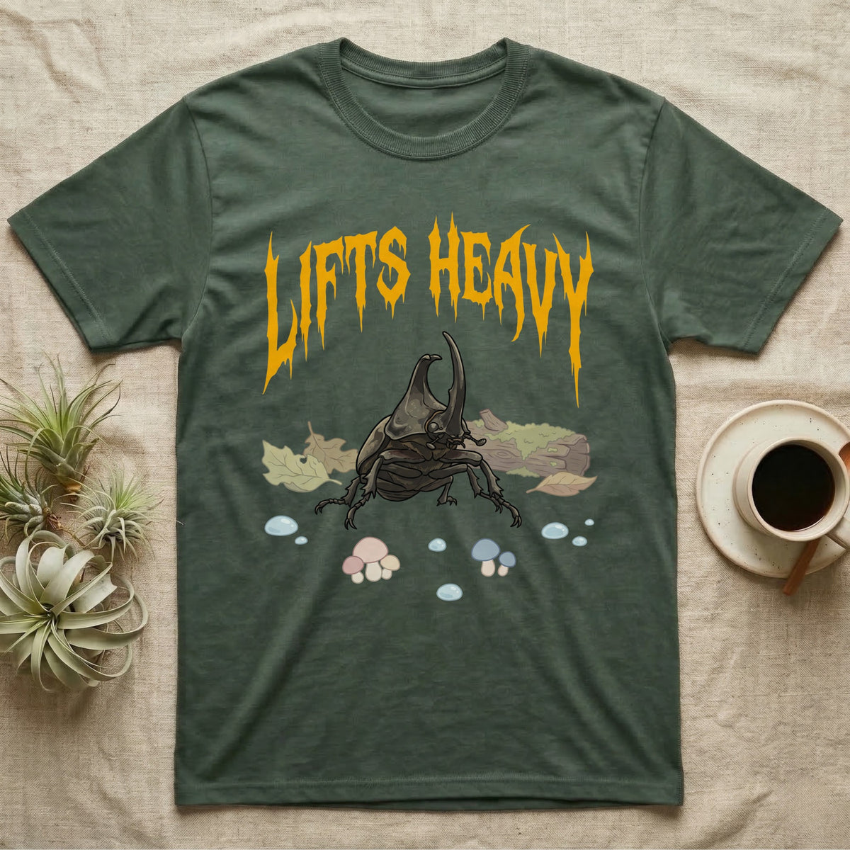 Rhino Beetle Feral T-Shirt in Military Green — Horned rhinoceros beetle standing head-on below a dripping amber-gold metal "Lifts Heavy" wordmark