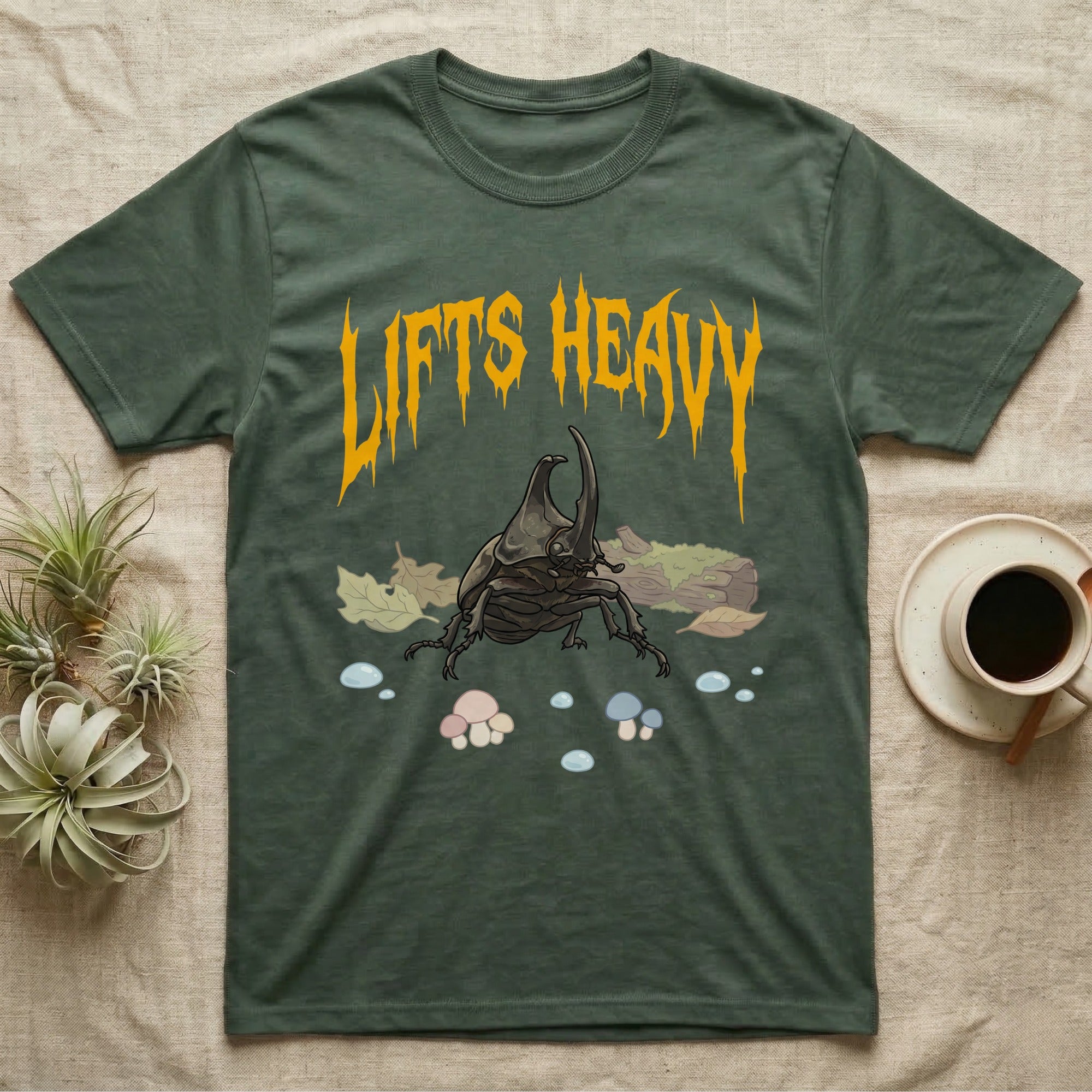 Rhino Beetle Feral T-Shirt in Military Green — Horned rhinoceros beetle standing head-on below a dripping amber-gold metal "Lifts Heavy" wordmark