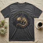 Dark gray t-shirt with golden axolotl illustration and "Monstrum Aquosum" text.