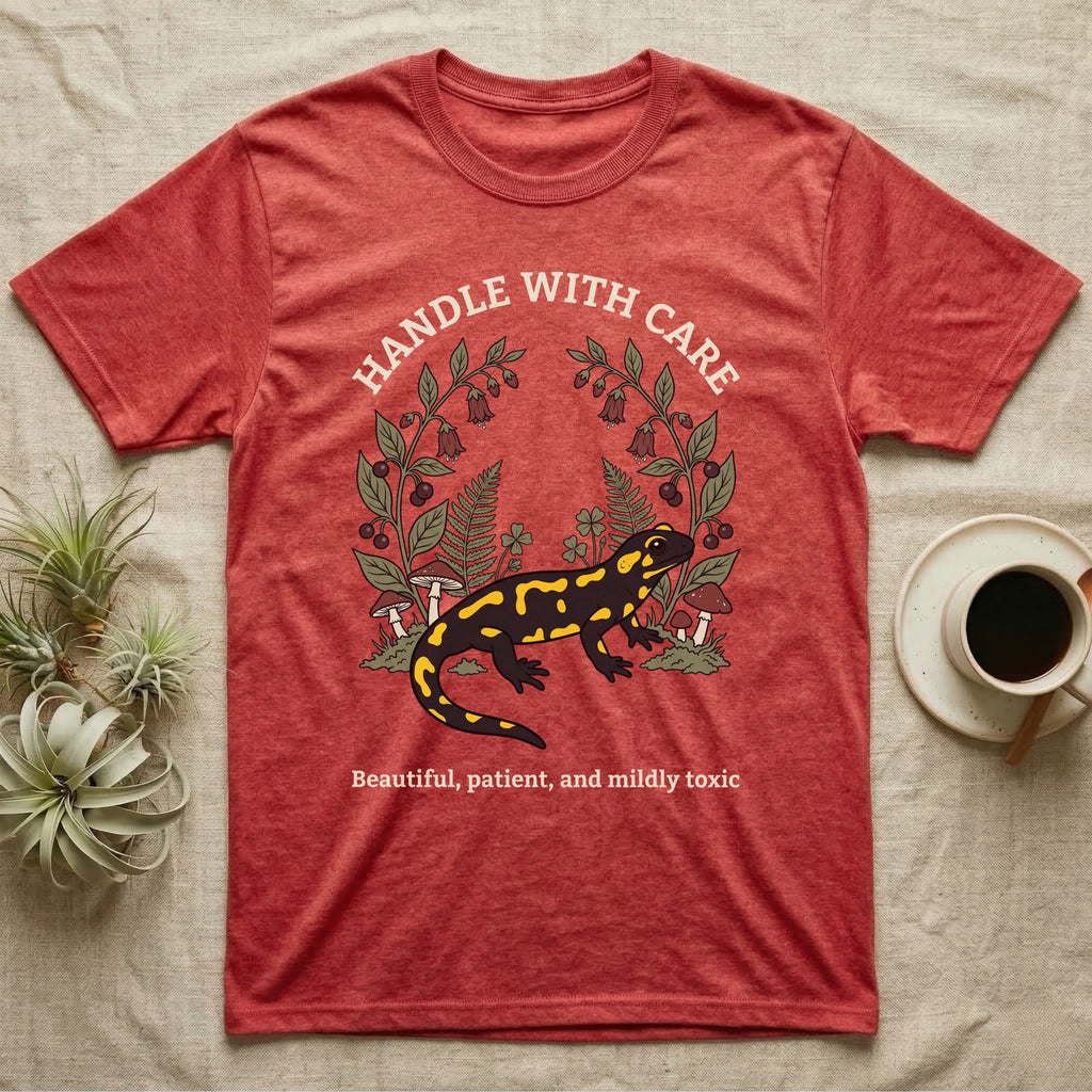 Fire Salamander Poison Plate T-Shirt in Heather Red — Naturalist apothecary-plate illustration of a fire salamander framed by a symmetric wreath of woodland botanicals.