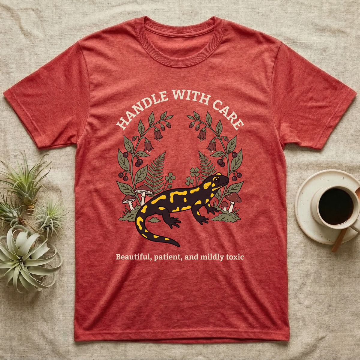 Fire Salamander Poison Plate T-Shirt in Heather Red — Naturalist apothecary-plate illustration of a fire salamander framed by a symmetric wreath of woodland botanicals.