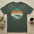 Ball Python Retro Sunset T-Shirt in Military Green — Ball python silhouette draped over a branch inside a retro striped sunset disc with monstera leaves on a tee